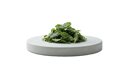 Dried leaves of Himalayan spearmint tea arranged on a round stone platform for herbal tea lovers